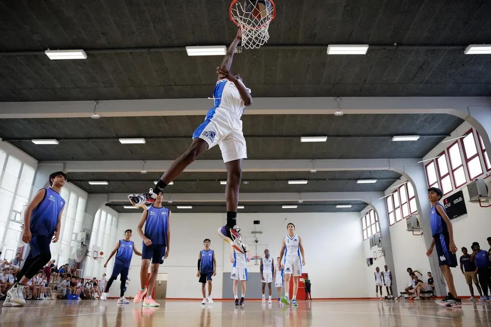 Young basketball player dunking