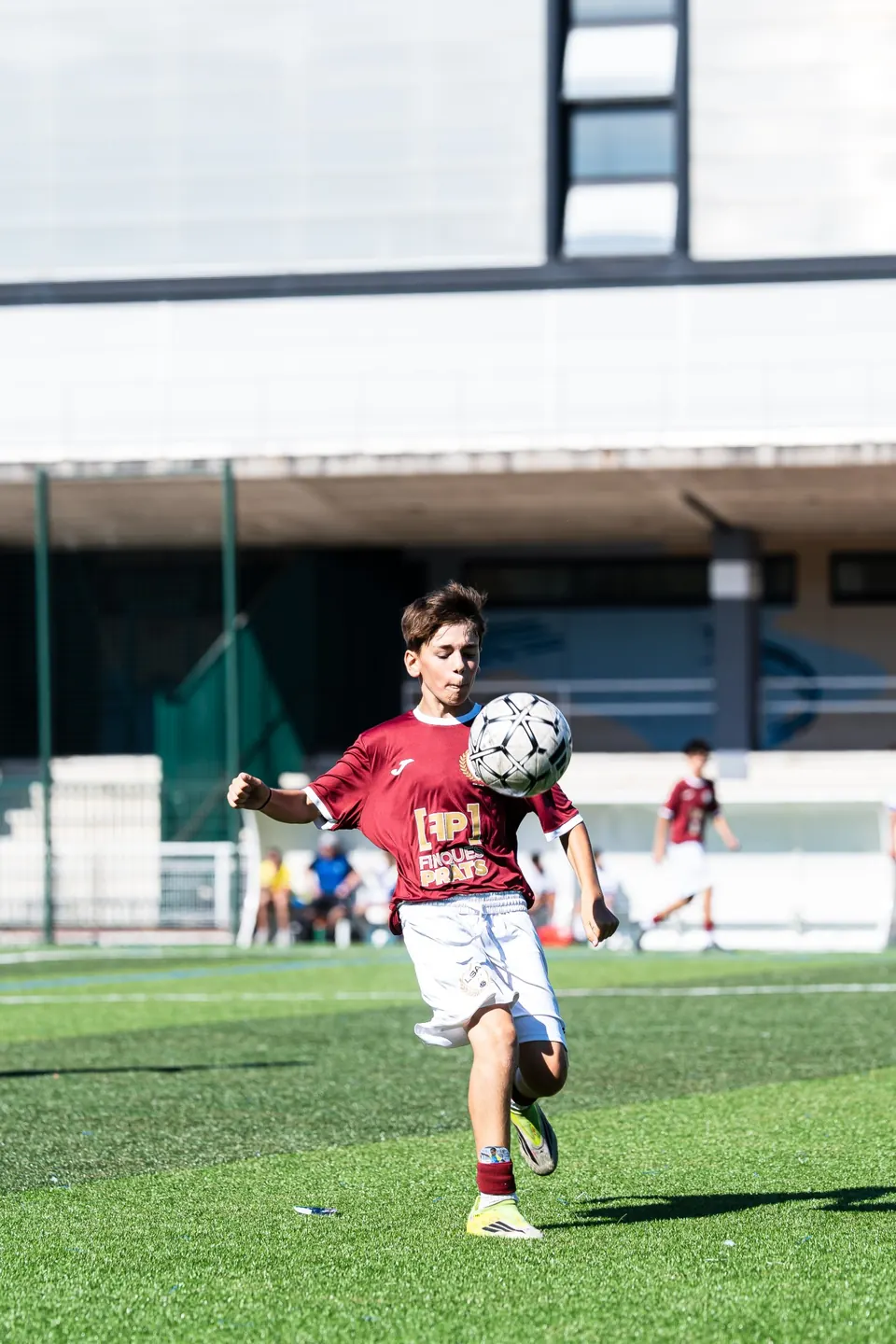 Young player controlling the ball with his chest