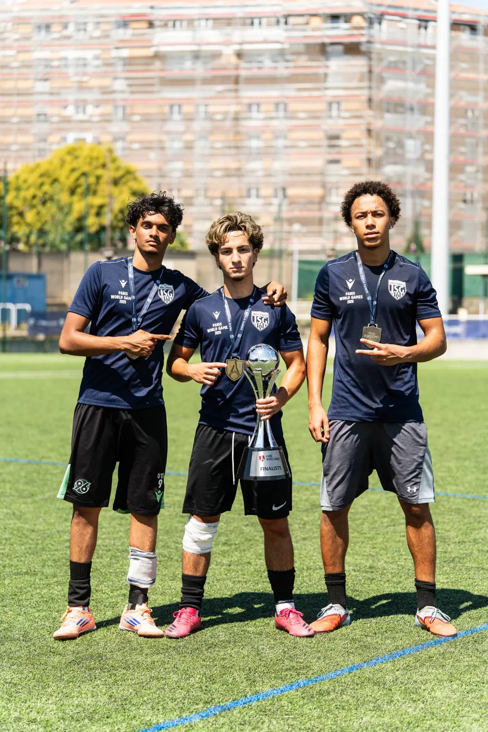 Three young players posing with their trophy